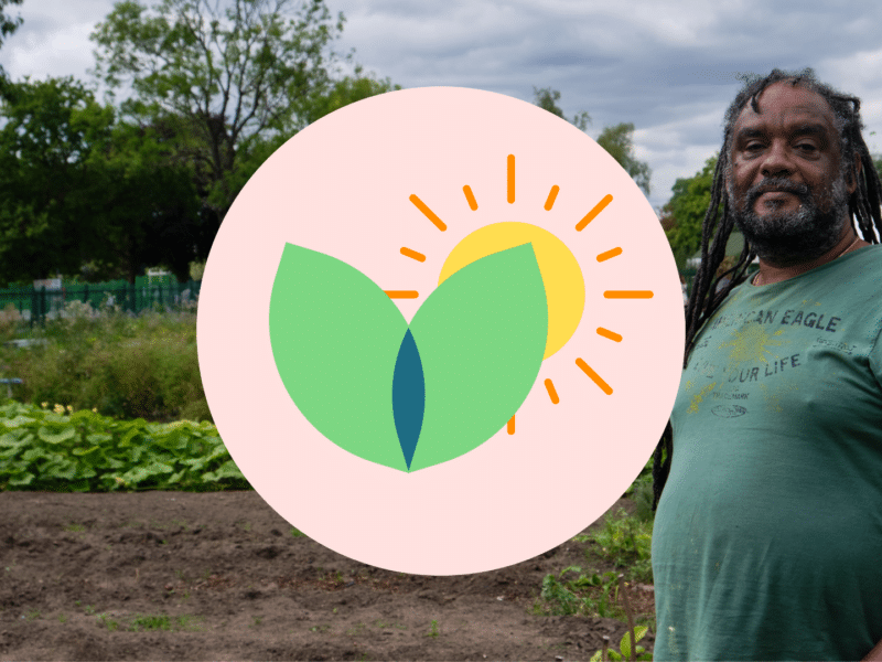 A photo of a black man with dreadlocks stood in an allotment
