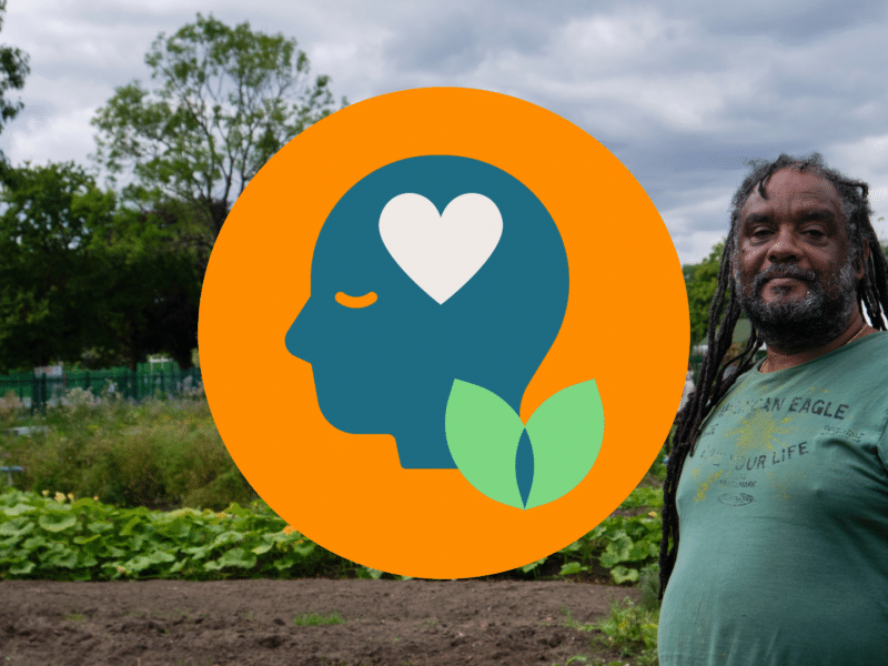 A photo of a black man with long dreadlocks and a grey beard standing in an allotment. Over the top is our 'Your Mind Matters' graphic which is an orange circle with a blue head illustration