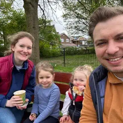 Milly with her husband and their two young daughters on a day out in the park.