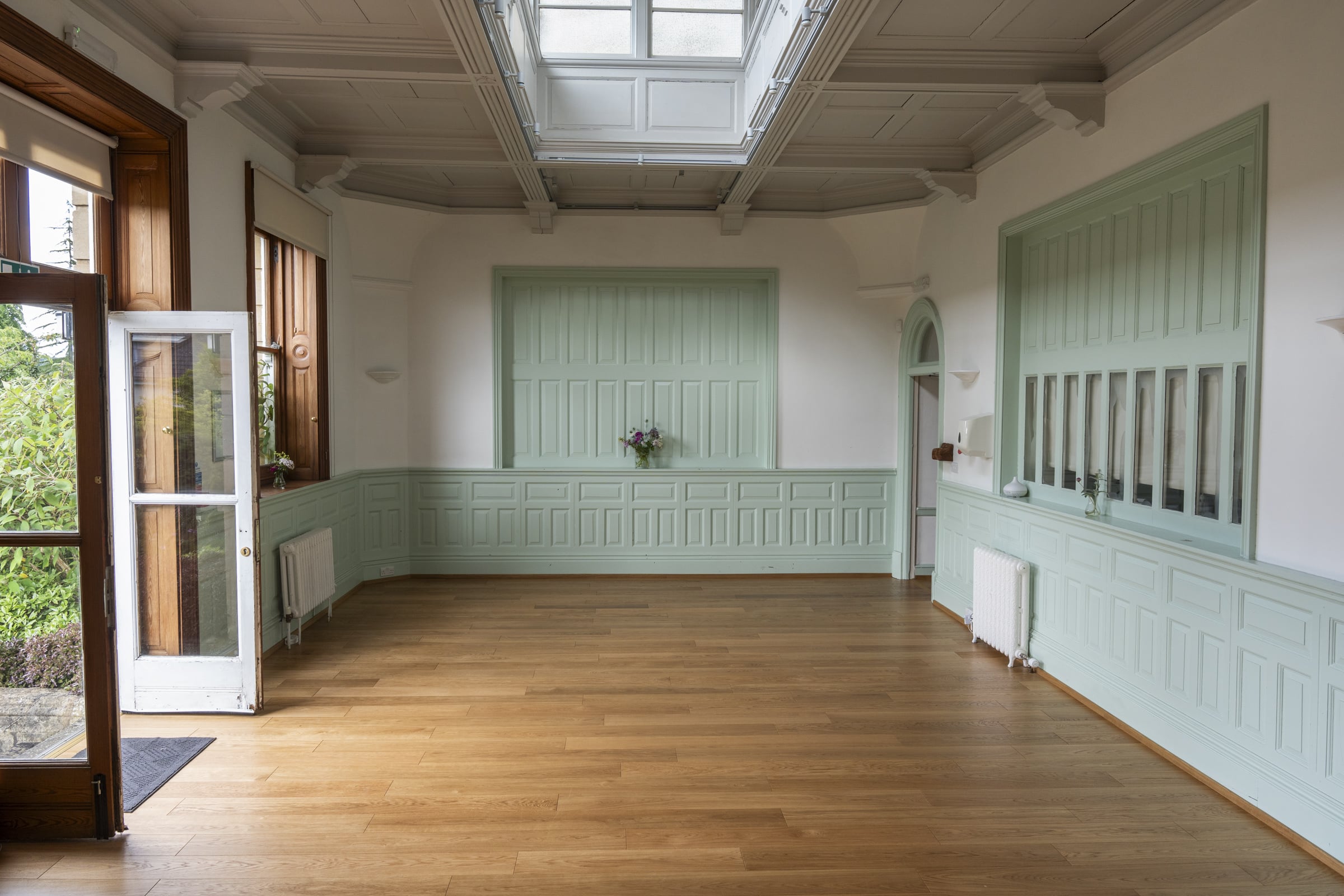 An open studio at the Centre with a wooden floor and a skylight